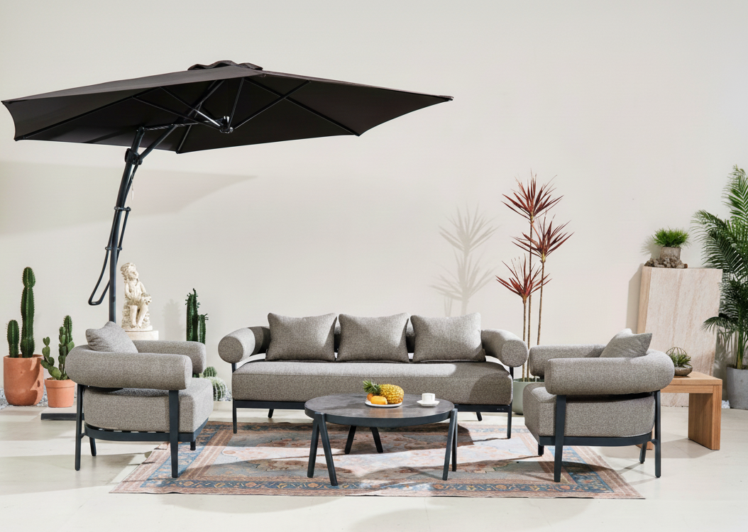 Direct Wicker Outdoor patio set with gray sofa, chairs, and umbrella in a modern living room setting.