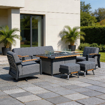 Outdoor patio furniture set with a fire pit table on a stone patio.