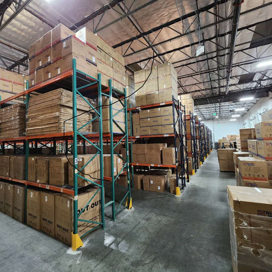 Direct Wicker warehouse interior with stacked cardboard boxes on shelves